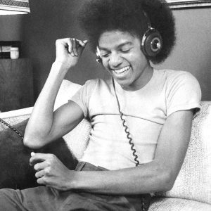 Michael Jackson listens to music via headphones in the 1970s.